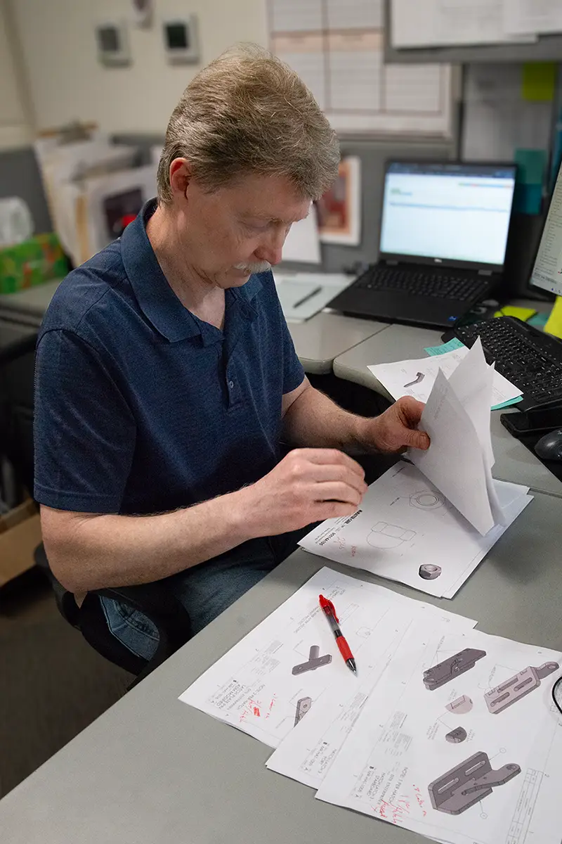 DTS-Design Engineer Looking through Designs