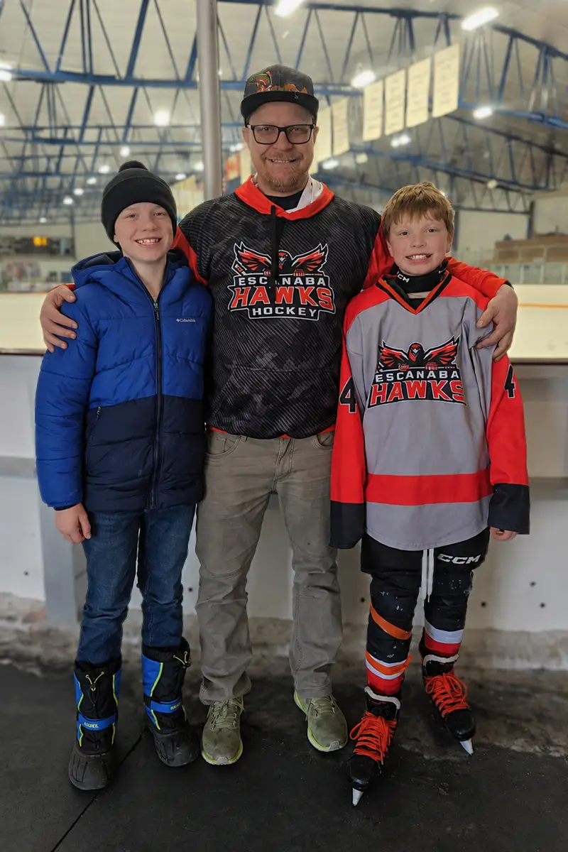 DTS Employee with two sons at hockey rink